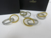 4 x L'OBJET Silver and Gold Napkin Rings, with Original Box.