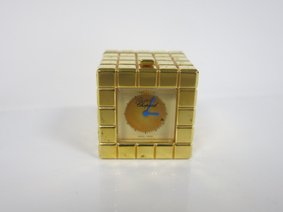 Chopard Ice Cube Desk Clock in Brushed Metal Gold with Blue Hands, S/N 51/8898/00 996759. Size 3.5 x 3.5 x 3.5cm.