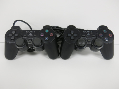 2 x Standard Black SONY PS2 Pads.