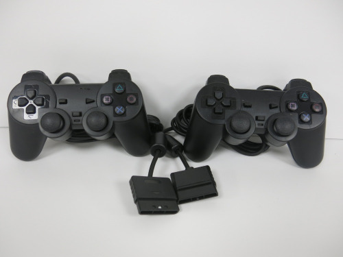 2 x Standard Black PS2 Pads.