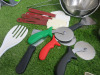 Quantity of Kitchen Utensils to Include: 6 x Spatulas, 2 x Scrapers,3 x Pizza Cutters, 7 x Ladles, 2 x Sieves, 29 x Assorted Sized Tongs, 1 x Salter Dietary Kitchen Scales, 6 x Kitchen Knives & 1 x Metal Chopping Board Holder & 5 x Assorted Chopping Board - 2