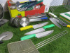 Quantity of Kitchen Utensils to Include: 6 x Spatulas, 2 x Scrapers,3 x Pizza Cutters, 7 x Ladles, 2 x Sieves, 29 x Assorted Sized Tongs, 1 x Salter Dietary Kitchen Scales, 6 x Kitchen Knives & 1 x Metal Chopping Board Holder & 5 x Assorted Chopping Board - 4