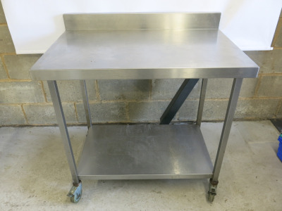 Stainless Steel Table on Castors with Part Splash Back & Shelf Under. Size H90 x W100 x D65cm.