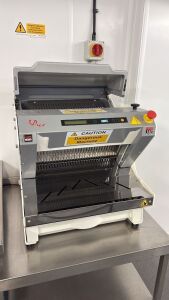 JAC Bread Slicer, Model MRK450-14, S/N 19100684, 240V, DOM 2019. Comes on Mobile Stainless Steel Prep Table. Size H70 x W82 x D76cm.