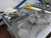 Large Assortment of Approx 60 x Commercial Kitchen Utensils to Include: Sieves, Scoops, Ladles, Paddles, Whisks Etc (As Viewed). - 2