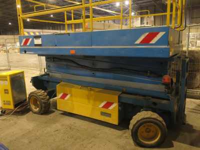 Holland Scissor Platform Lift, with Extending Working Platform (Circa 16ft). Type HLX108EL18, S/N X10800917, YOM 1990. Comes with Energic Plus Battery Charger, Model LF-3 80/120-0, DOM 02/2023, 3 Phase. Service Date 03/2025.