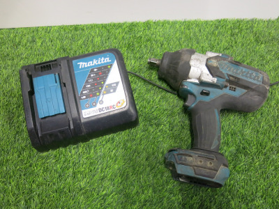 Makita Cordless Impact Wrench, Model DTW1002, 18V. Comes with Makita DC18RC Single Charger. NOTE: batteries required.