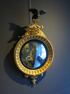 Regency Style Carved Giltwood Convex Mirror with Ebonised Eagle to Top. Size H100 x W55 x D17cm.