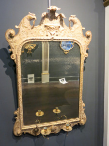 A Gessowork Looking-Glass, English, Circa 1720, Gilded Mirror with Bevelled Glass (19th Century) and 2 x Candle Holders. Size H103 x W67cm. NOTE: patina on glass.