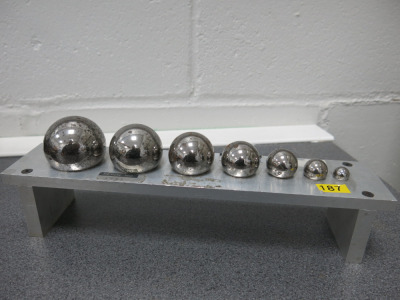 Set of 7 Weighted Steel Calibration Balls on Stand.