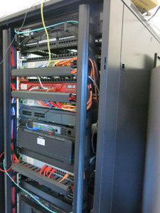 Server Rack Containing: Dell PowerEdge T410 Intel Xeon Server, Dell PowerEdge R630 with SSD Hard Drives, Synology 8 HDD Storage, APC UPS Battery Back Up Drobo 12 HDD Storage Unit, Watchdog 100-p Firewall, 2 x HP 2530-24G & Watchguard XTM 3 Series. NOTE: 