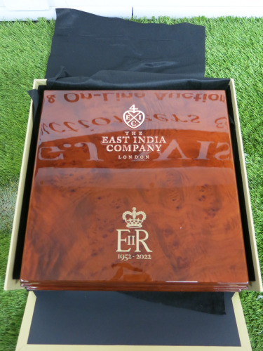 The East India Company Commemorative Queen Elizabeth 70th Jubilee Coin Collectors Box in Polished Wood with Gold Lettering and The Royal Cipher EIIR. Comes with 10 Coin Holder Insert & Pair of White Gloves. Size H9 x W 31 x D30cm.
