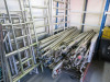 Approx 125 Assorted Pieces of Large Aluminium Scaffold Tower Component Parts to Include: 77 x Assorted Length Brace Bars, 32 x Stabiliser Legs, 9 x Frames, 3 x Stand Platforms & 4 x Trapdoor Platforms. - 3
