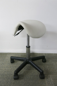 Height Adjustable White Saddle Massage Stool, with Black Legs.