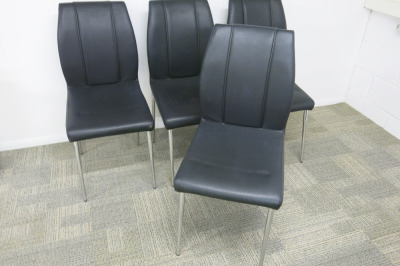4 x Black Faux Leather Chairs on Chrome Legs.