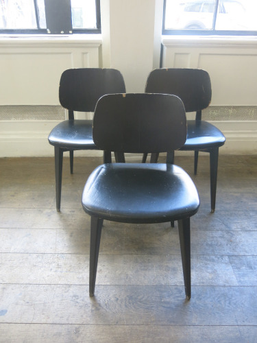 25 x Black Wood Dining Chairs Upholstered in Black Faux Leather, Condition As Viewed/Pictured.