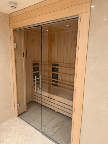 Harvia Fitted Sauna Unit with L Shape Seat, Glass Door & Front. Internal Size Approx 220 x 120 x H210cm. Located in Ladies Changing Rooms. NOTE: Located on-site Kensington High Street, requires collection by appointment only. The buyer will be required t