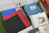 Lot of Assorted Materials to Include: Red Paper Folders, Blue Plain Lined Writing Books, Foam Sheets, Stabilizing Sheets & Air Freshener Kit. - 2