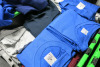 Large Stock of Basic Clothing Unbranded to Include: Hoodies, Jumpers, Jackets, T-Shirts, Polos, Beanies, Caps & HiVis Vests. All in Assorted Sizes & Colours. NOTE: crates not included. - 8