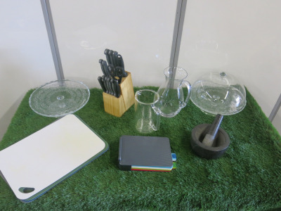 Assorted Lot of Kitchen Accessories to Include: Mortar & Pestle, Block of Knives, Assorted Chopping Boards 2 x Glass Jugs, 2 x Glass Cake Stands with 1 x Dome.