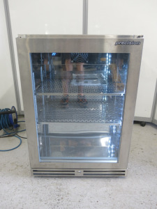 Precision Stainless Steel Single Glass Door Bottle Cooler, Model BBS600, S/N 195548. Size H85 x W60 x D50cm. Comes with Keys & Operating Instructions. NOTE: installed new and appears never used.