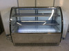 Diaminox Curved Glass Display Fridge with Black Finish & Stainless Steel Base, Model DX-1500CF2. Size H120 x W150 x D73cm. NOTE: damage to rear sliding door As Viewed/Pictured.