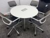 Orangebox Round Meeting Table & 4 x Steelcase Chairs to Include: 4 x Steelcase 57400-Sarrebourg Grey & White Mesh Back Swivel Chairs & White Round Table with Centre Power Unit. Table Dia 120cm.