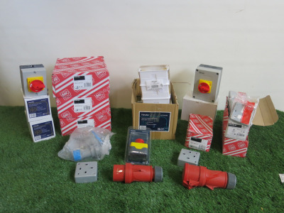 Crate Containing an Assortment of Electrical Consumables to Include: 4 x Assorted Newlec Switches, 3 x Industrial Plugs, 1 x Newlec Enclosed E Stop, 13 x MK 13A DP Switch Connection Units & 4 x Assorted MK Electrical Fittings. Crate Not Included.