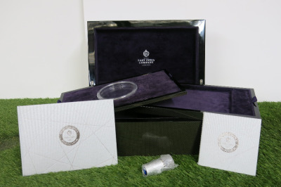 The East India Company Queen Elizabeth II Diamond Jubilee Carbon Fibre Coin Chest with Purple Velvet Interior, 2 x Silver Coin Information Books, Gold/Diamond Jewellery Magnifying Tool & 2 x Carbon Fibre & Purple Velvet Lined Trays. Comes with Original Bo