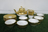 Lot of The East India Company Royal Bone China Toon Noon 18ct Gold Hand Painted Crockery to Include: 1 x Tea Pot, 1 x Mug with Strainer, 1 x Sugar Pot without Lid, 5 x Cups & 5 x Saucers.