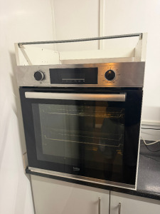 Beko BBXIF243XC Electric Stainless Steel Oven, in White Wooden Counter Top Case with Shelf.