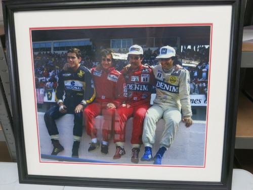 Photograph "Wall of Champions" Ayrton Senna, Alain Prost, Nigel Mansell, Nelson Piquet. Signed over the images of Mansell. Mounted, Framed & Glazed. 66cm x 56cm.