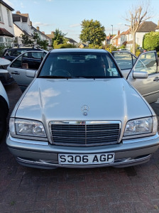 S306 AGP: 1998 Mercedes C200 Elegance Auto Saloon in Silver. Petrol, Auto, 1998cc. MOT Expires 28th June 2027. Comes with Full Service History, V5 & Keys.