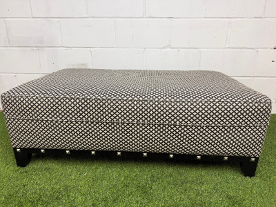 Large Rectangular Footstool in Black & White Geometric Pattern Upholstery with Metallic Stud Detail on Black Wooden Leg Base. Size H43 x W120 x D75cm.