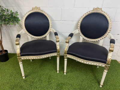 Pair of Louis XVI Style Carved Gilt Armchairs in White with Gold Painted Detail & Royal Blue Satin Upholstery with Three Rose Finial to Top.