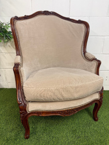 A Louis XV Style Walnut Bergere Armchair in Neutral Coloured Velvet Effect Upholstery. NOTE: requires minor repairs to backrest where fabric separated from frame.