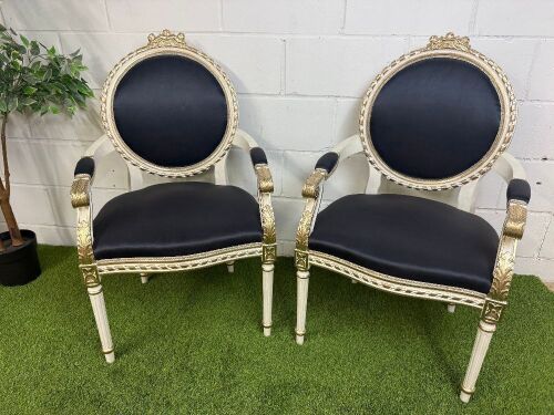 Pair of Louis XVI Style Carved Gilt Armchairs in White with Gold Painted Detail & Royal Blue Satin Upholstery with Three Rose Finial to Top.