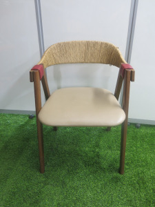 Designer Patricia Urquiolas Mathilda Chair for Moroso. Curved Plywood Backrest Encased in Woven Rush.