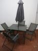 Outdoor Garden Patio Set in Dark Grey Metal. 1 x Table with Tempered Metal Glass Top, 4 x Folding Chairs & 1 x Wind Out Umbrella. Table Size H70cm x W90cm x D90cm - 4