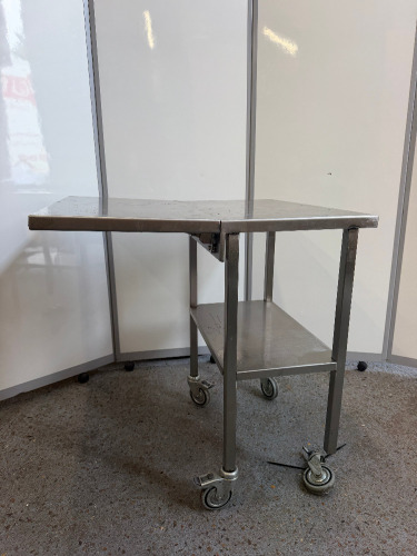 Mobile Stainless Steel Table with Shelf Under & Collapsable Extender. Size H85 x W75 x D42cm. NOTE: one wheel requires repair.