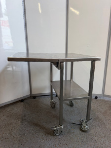 Mobile Stainless Steel Table with Shelf Under & Collapsable Extender. Size H85 x W75 x D42cm. NOTE: one wheel requires repair.