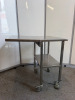 Mobile Stainless Steel Table with Shelf Under & Collapsable Extender. Size H85 x W75 x D42cm. NOTE: one wheel requires repair.