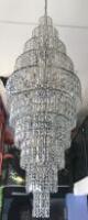 10 Drop Tier Chandelier in Chrome with Plastic Droplets. Size (H) 180cm x (Dia) 60cm. NOTE: Location for viewing & collection by appointment in Canterbury, Kent. Buyer will be required to disconnect & dismantle.