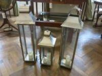 3 x Chrome Garden Lanterns. Size H85cm x W23cm x D23cm & H55cm x W23cm x D23cm. NOTE: Glass broken to 3 panels (As Pictured)