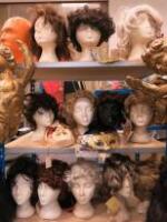 3 Shelves Containing 12 x Polystyrene Mannequin Heads with Qty of Assorted Wigs, Extensions & Venetian Face Masks