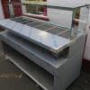 New/Unused (Manufactured July 2017) TFSE Products Ltd, Café Counter Heated Wet Well Bain Marie Servery. Model SM1750-740BM.Quartz Heat Lit Gantry with Toughened Glass Screen Top, Front & Sides. Stainless Steel Construction with Red Laminate Fascia. Size H - 4