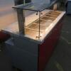 New/Unused (Manufactured July 2017) TFSE Products Ltd, Café Counter Heated Wet Well Bain Marie Servery. Model SM1750-740BM.Quartz Heat Lit Gantry with Toughened Glass Screen Top, Front & Sides. Stainless Steel Construction with Red Laminate Fascia. Size H - 9