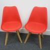 Pair of Habitat Jerry 120858 Dining Chairs in Molded Plastic with an Upholstered Seat Pad and Solid Oak Legs. Colour Red