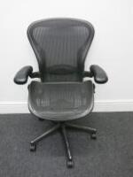 Herman Miller Aeron Ergonomic Adjustable Mesh Office Chairwith Lumbar Support, Adjustable Arm Rests & Vinyl Arm Caps.Size B.NOTE: seat pan requires refurbishment (As Pictured/Viewed). 