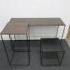 Set of 3 Black Assorted Sized Metal Framed Display Tables with Wooden Insert to Include: 1 x H75 x W129 x D43cm, 1 x H85 x W43 x D43cm & 1 x H45 x W43 x D43cm. NOTE: small table missing wooden insert.